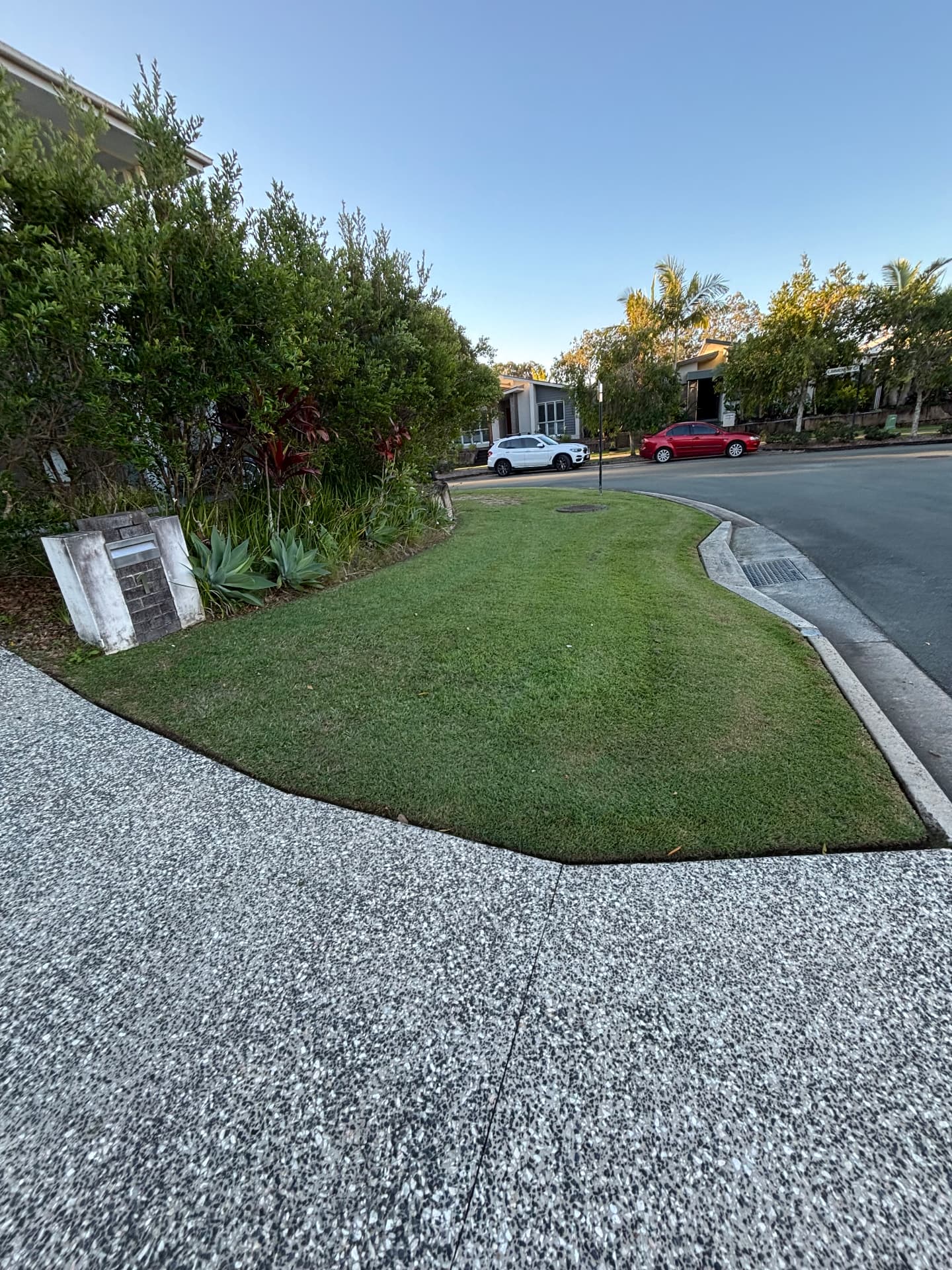 Neatly cut corner verge lawn with crisp concrete edges